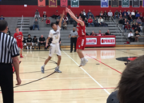 Jingco fires a shot from behind the three point arch during the team’s home opener against Fridley. “He finishes around the basket very well along with being a good shooter,” Hannigan says.