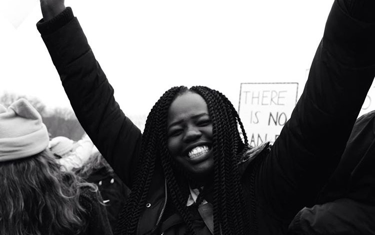 Junior Bakange Ajak smiles while marching at the Women’s March in St. Paul on Jan. 21. I marched because of the rights that I have being in danger. I marched for my African brothers and sisters being targeted. I marched for the future of our country and its future leaders, Ajak says. 