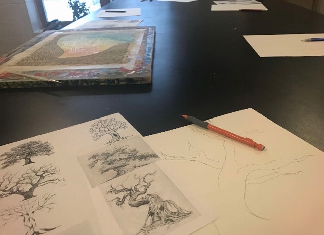 Some of the students art work sprawled out across a table in the art room.“Last semester I got a recommendation letter from Weese, she told me I should try AP Studio Art. She was my graphic design teacher last year,” senior Andrea Gomez Molano says.