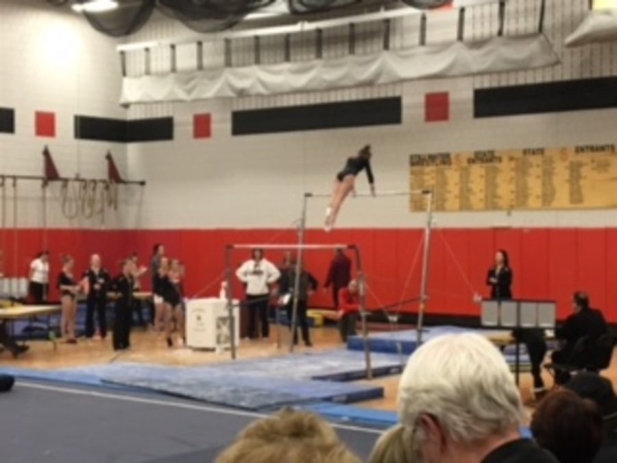 The team stands by and watches as a teammate completes her beam routine. One can feel the sense of team from watching as the girls are constantly cheering and encouraging one another. “We have grown so much just within the season, and are continuing to grow with our skills, and that has allowed us to score much higher than in the recent years,” sophomore Peyton Classon says. 
