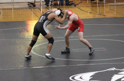 Junior, Jared Christian working his opponent in the Roseville meet. "We have a lot of motivated guys on the team this season, and it's really good to have a team that is bigger than just a few star athletes," Tyler Olsen says.