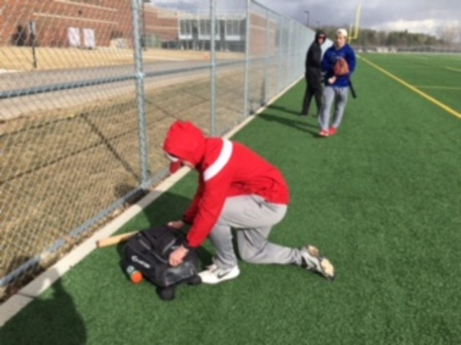 Senior David Johnson putting away his glove after a productive captains practice on the turf at SAHS. Junior Mason Schwerzler says, “The turf is very convenient to have at the high school for baseball. The turf gives us a place to practice despite conditions.”
