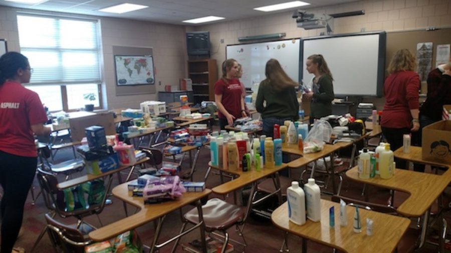 Officers and members of Amnesty Club quickly sort the different hygiene items onto various desks. Amnesty is a club interested in working for human rights, junior Amelia Torgerson says.