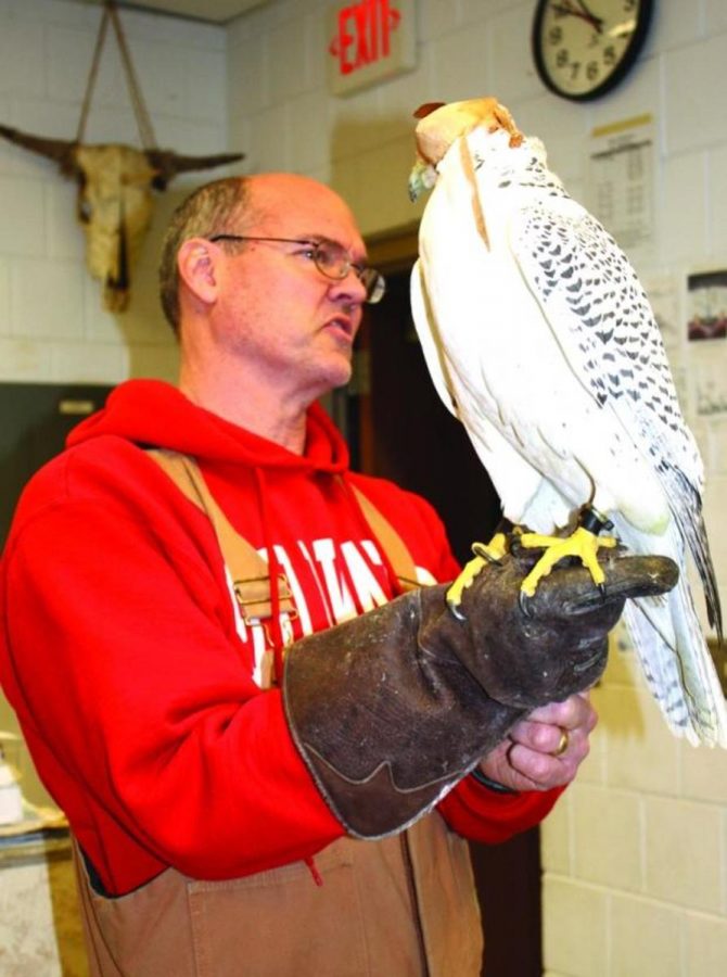 Photo courtesy Andrew Weaver 
Weaver stands with the falcon he has raised and talks to his students about it.  “I think I was nominated because its doing more than somebody else with the same job. I take advantage of the opportunities this teaching job has given me, such as raising falcons and doing things I’m passionate about while spreading on that love and excitement to my students,” Weaver says.