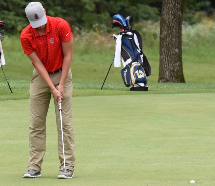 Anderson focuses as he takes a put. Competition is valued on the golf team and Anderson adds to that spirit. Parker and I are really competitive so we are always trying to beat each other which makes both of our games better, junior Cole Janke says.