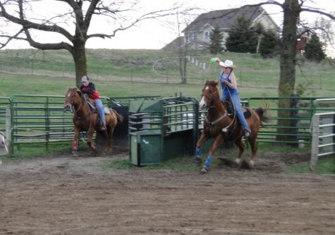  Caitlin and Brandon Pott on their horses Five and Rusty coming out of the box after the roping dummy during practice. “I’ve fallen off a couple of times. Mostly just rope burns and bruises,” Caitlin said.