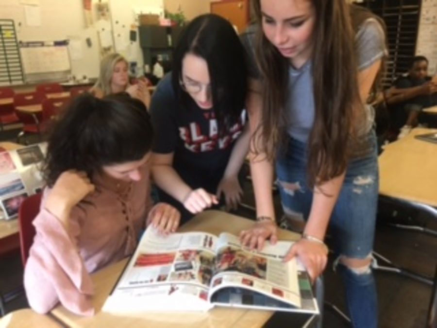 Seniors Maddie Huntley, Abby Abrahamson and Sarah McCarthy all look at a yearbook and discuss what you can and can’t do when it comes to editing a photo. “There is always limits to what you can and cant do with a photo. You certainly couldnt distort a photo or falsify a photo in order to create an image of something that never happened,” McCarthy says. 