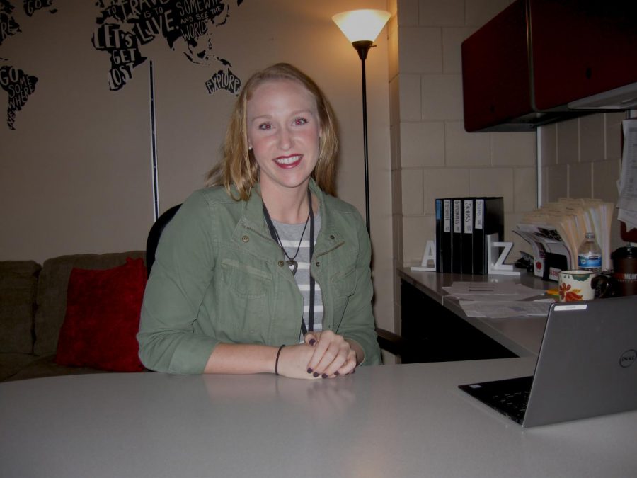 Koenen smiles behind her desk, welcoming students to come and meet her. 
