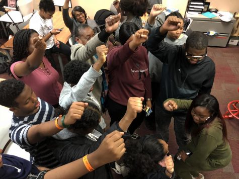 Black Student Union members lift their hands up in a protest fist, which represents unity, strength, and defiance or resistance. Sophomore Nawal Mukhtar explains, “BSU is a family, not just a club.”