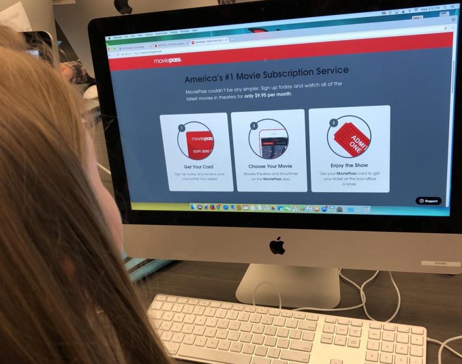 Student pictured in the publications room. Seen signing up for a MoviePass. A website/app to allow cheaper access to movies showing in theaters.