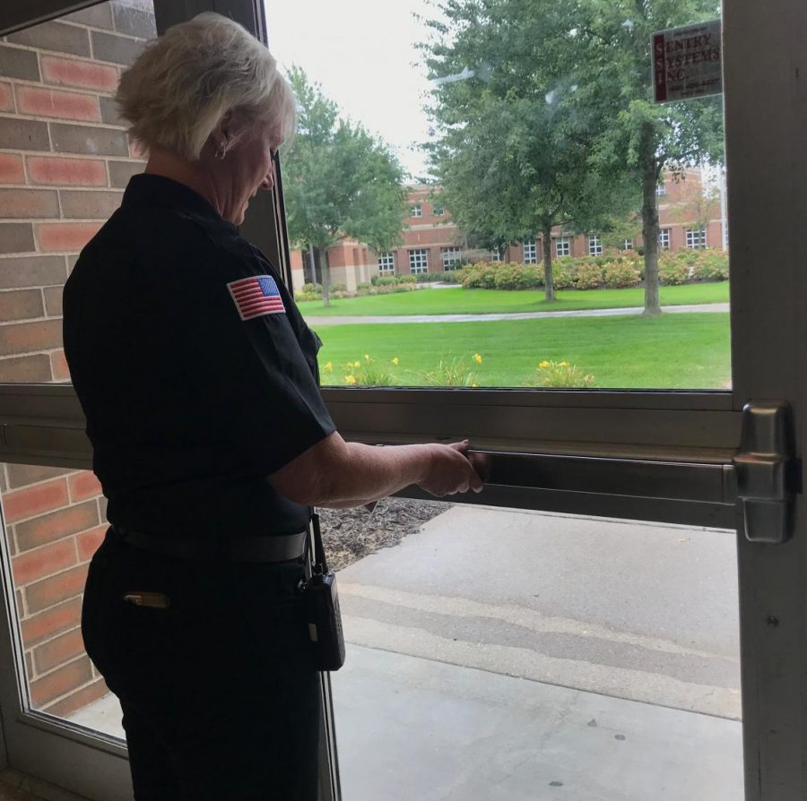 Security officer Joann Sandahl locking a main door into the school to prevent any unauthorized entry. I want students to understand the bigger picture. Nobody wants to feel like they have to have doors guarded and locked to feel safe, but we have to be proactive and watching for warning signs, says Assistant Principal Chris Otto.