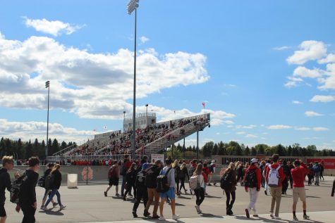 Students file into the bleachers for the annual Homecoming pep fest Sept. 28.