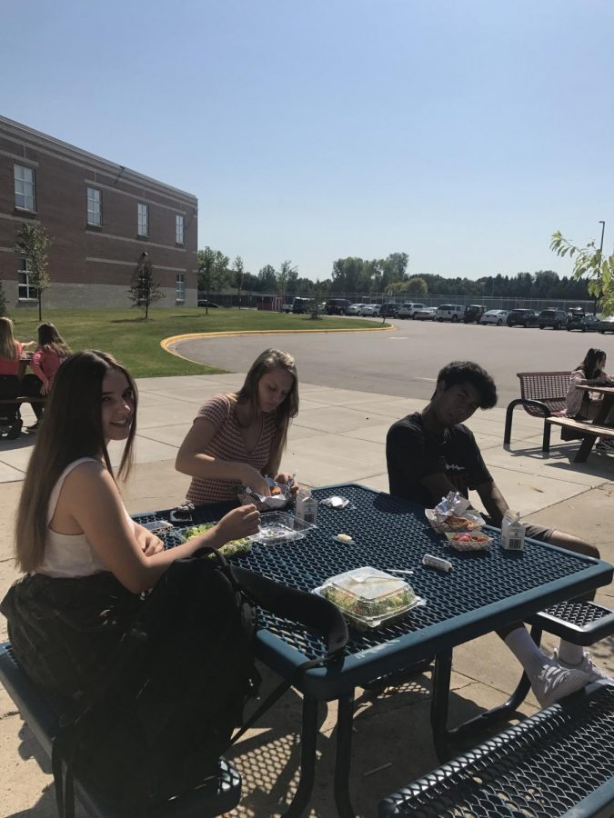 Juniors Dylan Stormoen, Rosie Nichols and Sam Kavapalu eating lunch outside.This was during A lunch on Friday, September 14. 