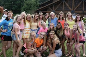 Young Life girls having fun at Castaway camp during the nineties night.