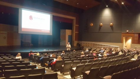 Principal Rob Bach and community members meet in school auditorium for a discussion regarding student vape use.  
