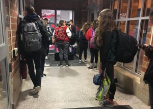 Students stand patiently by the locked doors before 7:10, waiting for to be released into the building and begin the day.