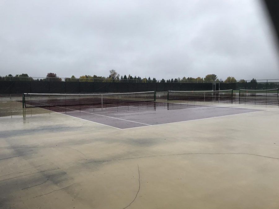 The tennis team practices on the tennis courts right behind the high school. The team does not practice when it is raining outside. They also do not have anymore practices for the season because they lost a section game.