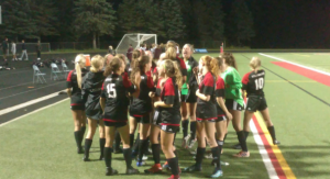 Girls varsity soccer team huddles before winning game played at home VS Roseville. The team ended regular season with 18 wins, 1 loss, and 4 ties.