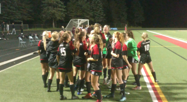 Girls+varsity+soccer+team+huddles+before+winning+game+played+at+home+VS+Roseville.+The+team+ended+regular+season+with+18+wins%2C+1+loss%2C+and+4+ties.