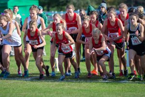 The varsity girls cross country team starts off strong at their conference meet. Sophomore Ana Weaver (in red, farthest to the left) starts off on the right foot at the girls conference meet. 