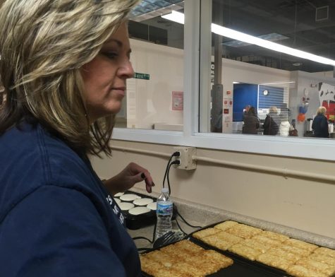 ASL teacher Amy Caslow flips hash browns at Metro Deaf School on Nov. 10. She, along with many of her students, were volunteering at the Pancake Breakfast fundraiser. 
