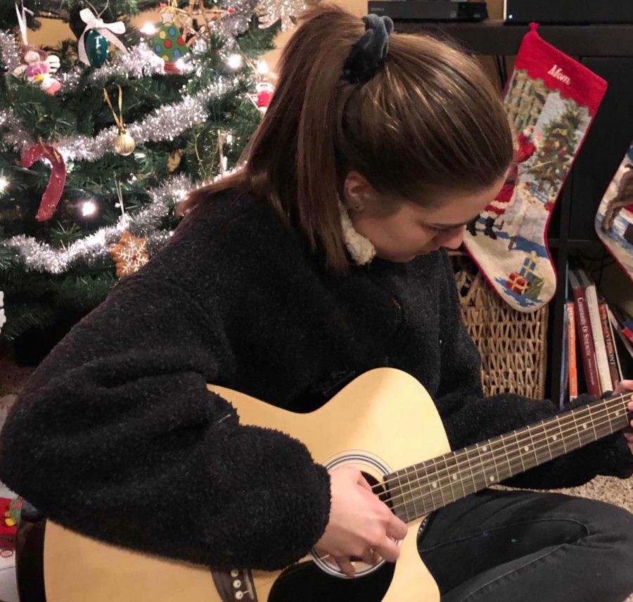 Lysne rehearses on her guitar for the Coffeehouse concert. So far, she has performed in every winter and spring concert she could audition for in her high school career.