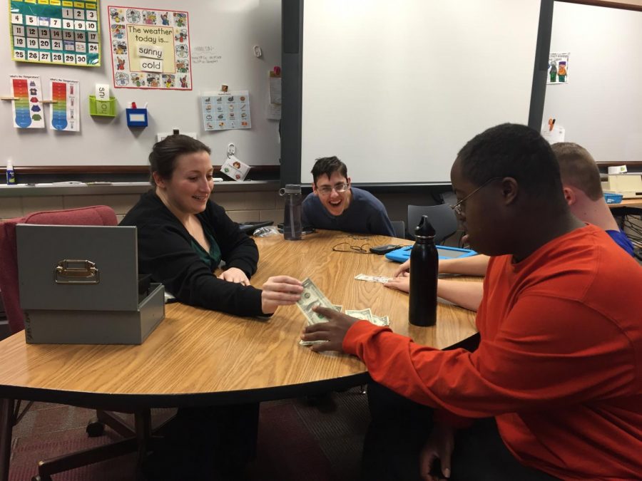 Special education teacher Nicole Schroepfer works with her students to help them learn to count money and prepare them for the world outside of the classroom.
