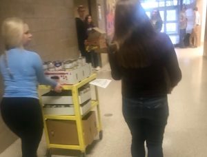 National Honor Society students help transport the food from a first hour class. They put the food near a door so it can be brought to Valley Outreach for families on Nov. 21. 