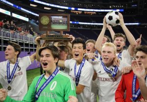 Members of the boys soccer team pose with the 1st trophy after winning the game 2-1 at the US Bank Stadium in Minneapolis.