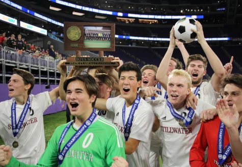 Members of the boys soccer team pose with the 1st trophy after winning the game 2-1 at the US Bank Stadium in Minneapolis.