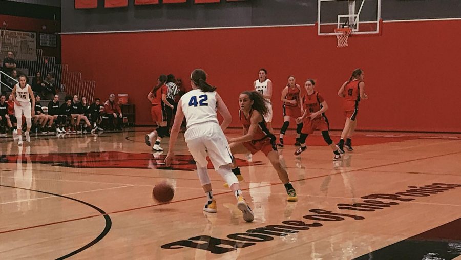 Sophomore Alexis Pratt hustles back on defense on the Dec. 17  game against Wayzata. The Ponies fell by two points to the Trojans in overtime.