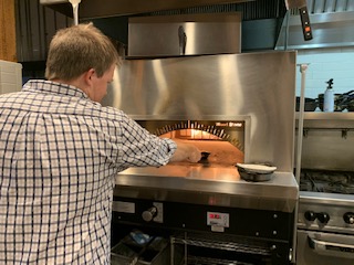 A wood-fire oven is used at Manger for a unique way of preparing their dishes. Owner Mike Willenbring is seen here cooking a cut of beef tenderloin on a skillet in the wood-fire oven. 