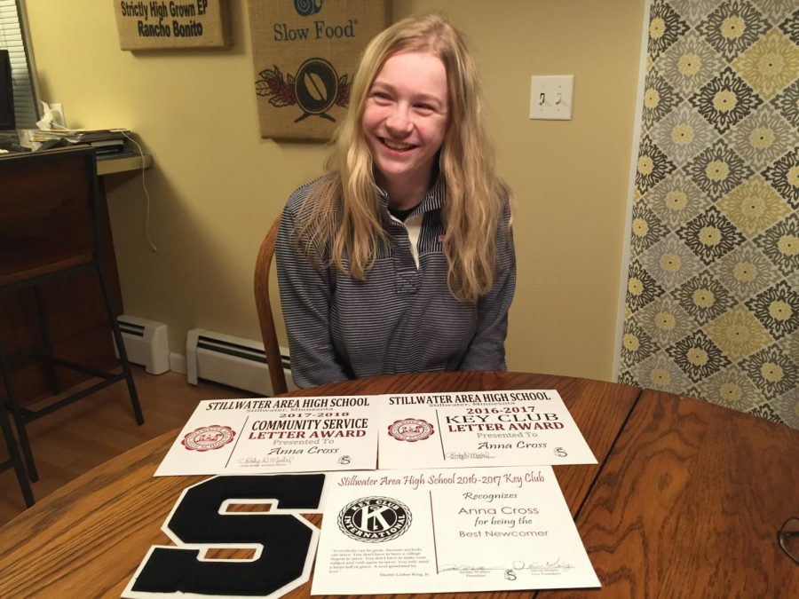 Senior Anna Cross shows off just a few of her awards she has earned by many years of volunteer work.