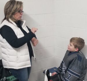 Caslow uses sign language to communicate with her son AJ about how he felt about how he did as goalie. This was after his hockey practice on Jan. 4.