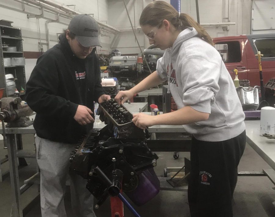 Students from the 916 career in tech program work on taking apart a car engine for their class. The 916 program keeps students more engaged in their learning compared to a normal classroom setting, which gives students a boost of experience going into college.