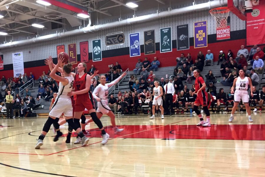 Senior Liza Karlen drives into the other player to try to block a shot. They were playing Shakopee last year.