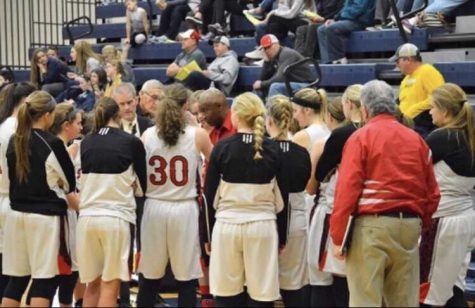 The girls basketball team prepares to play against Tartan Dec. 30. The girls are talking with each other about strategies to win the game.