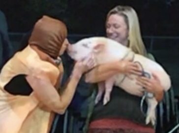 Anderson Principal Anna Wilcek gives a pig a kiss after her students raised almost $10,000.  The pig, named Mr. Bilbo Bacon, is owned by Kari Patsy, a small business owner in downtown Stillwater.
