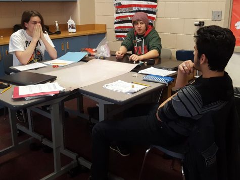 Dungeons and Dragons club debate over semantics. Pictured from left to right are junior Rowan Bell-Myers, senior Nathan Breisler, and senior Aztlan Sanchez. The other two members, senior Tyhlir Lowry and junior Aaron Mozey were not present at the session on Feb. 12. The adventuring frequently gets side-tracked when someone brings up memes or the practicalities of magic in real life.