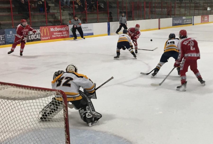 A puck flies towards the net while senior forward Wyatt Wasko skates through the right wing. Stillwater defeated Mahtomedi 2 to 1 in one of the final games of the regular season.