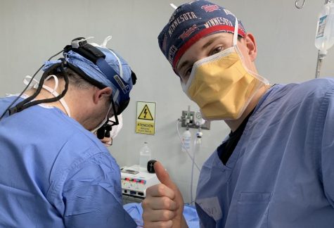 Junior Tyson Fredkove poses with a doctor in Peru. The two prep a Peruvian child with a cleft lip for their correction surgery. 