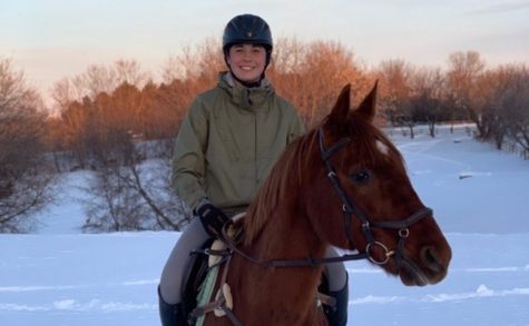 Freshman Lousia Ward rides Wondergirl through the snowy hills in the Minnesota forest on a windy Saturday morning.