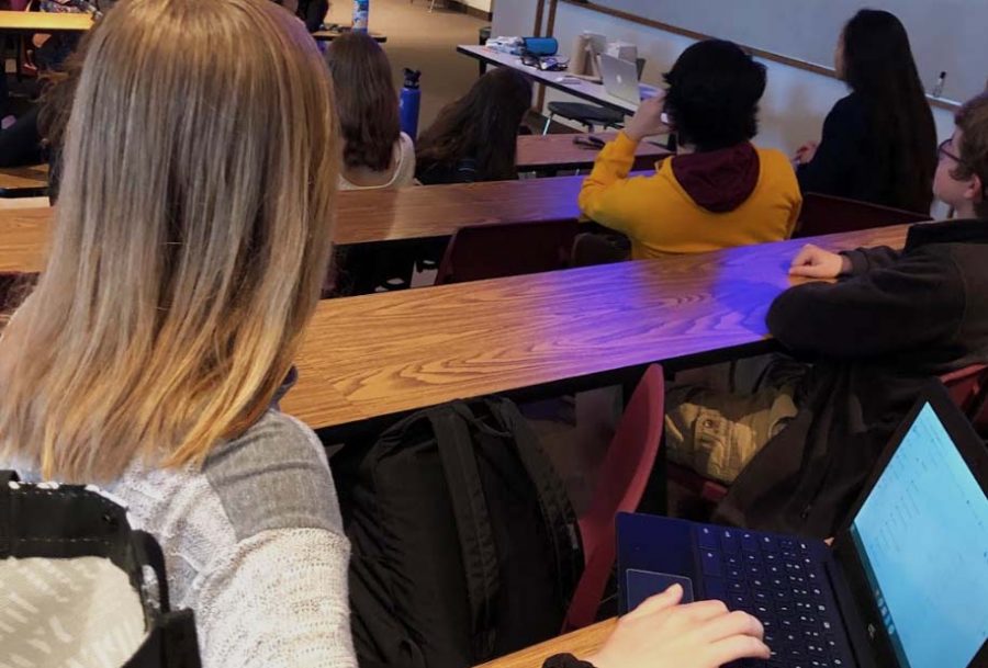 Junior Elise Riniker attentively watches a lecture. Her academic merit was advantageous to her in her student council election campaign. 