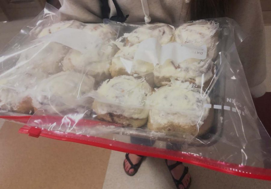 Marquez carries a batch of her homemade cinnamon rolls. The proceeds from the cinnamon rolls go to the cost for her mission trip to Brazil.