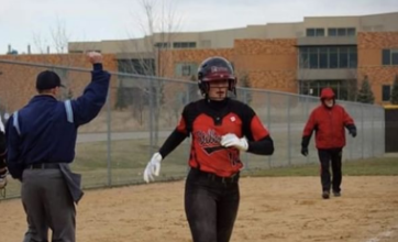 Junior Haley Eder-Zdechlik #14 on the girls softball team runs into home base during their game against Mounds View on April 16. Eder-Zdechlik has been working hard this season to help get her team back to state to defend their title.