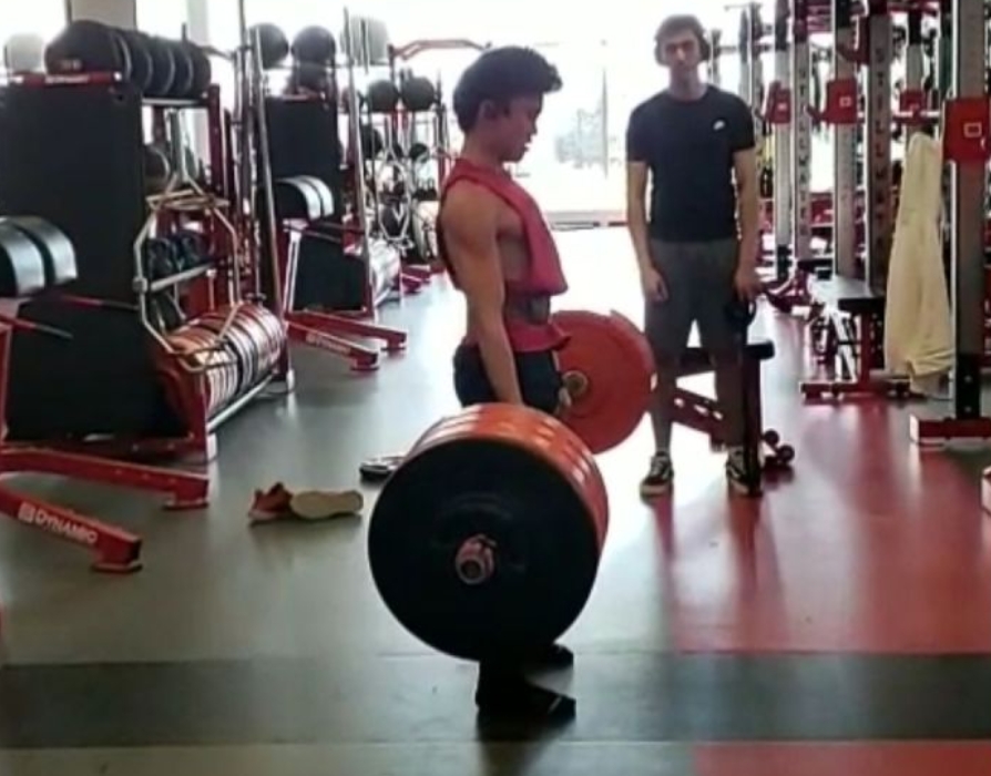 Eli Wilson dead lifting to prepare for wrestling. Eli is interested in boxing.