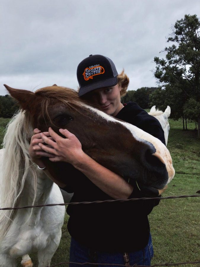Senior Brandon Pott shows off his horse after school at his farm in Wisconsin. Brandon makes sure to show care for his animals as he tends to his farm.  