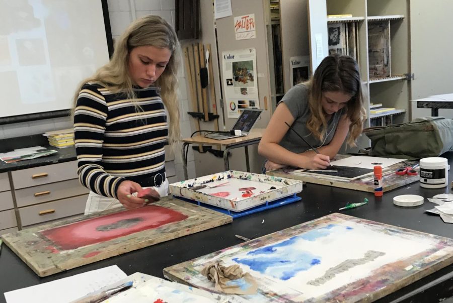Seniors Faythe Hendry and Taylor Venancio explore different techniques to create their own unique versions of a tree in Mr. Koltun's painting class. The class struggles to provide supplies for students without generous donations from students, which are not required when signing up for the course.