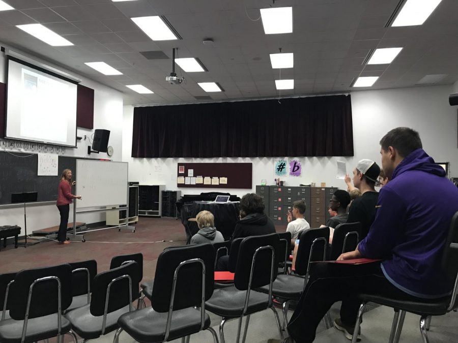 Choir Director Angela Mitchell leads vocal warm ups with basses before Tuesday sectionals. Each member of the Stillwater Choir is required to attend sectionals once a week at 7 a.m. before school.
