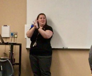 ASL teacher Amanda McKinnon reviews previous course content with her ASL 3 class on the morning of Sept. 12. She demonstrates the sign for borrow.